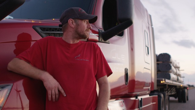 Photo of JLE Professional Flatbed Driver next to his truck