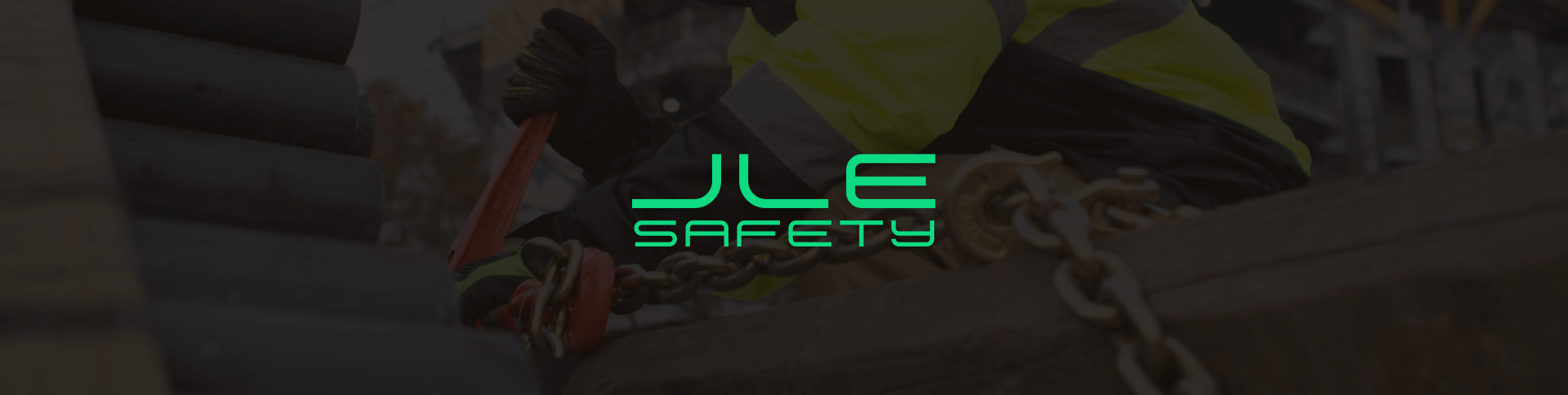 Photo of load being secured on a flatbed trailer with the words JLE Safety overlayed on top